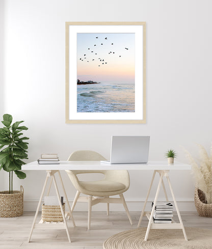 coastal office decor featuring framed blue beach photograph